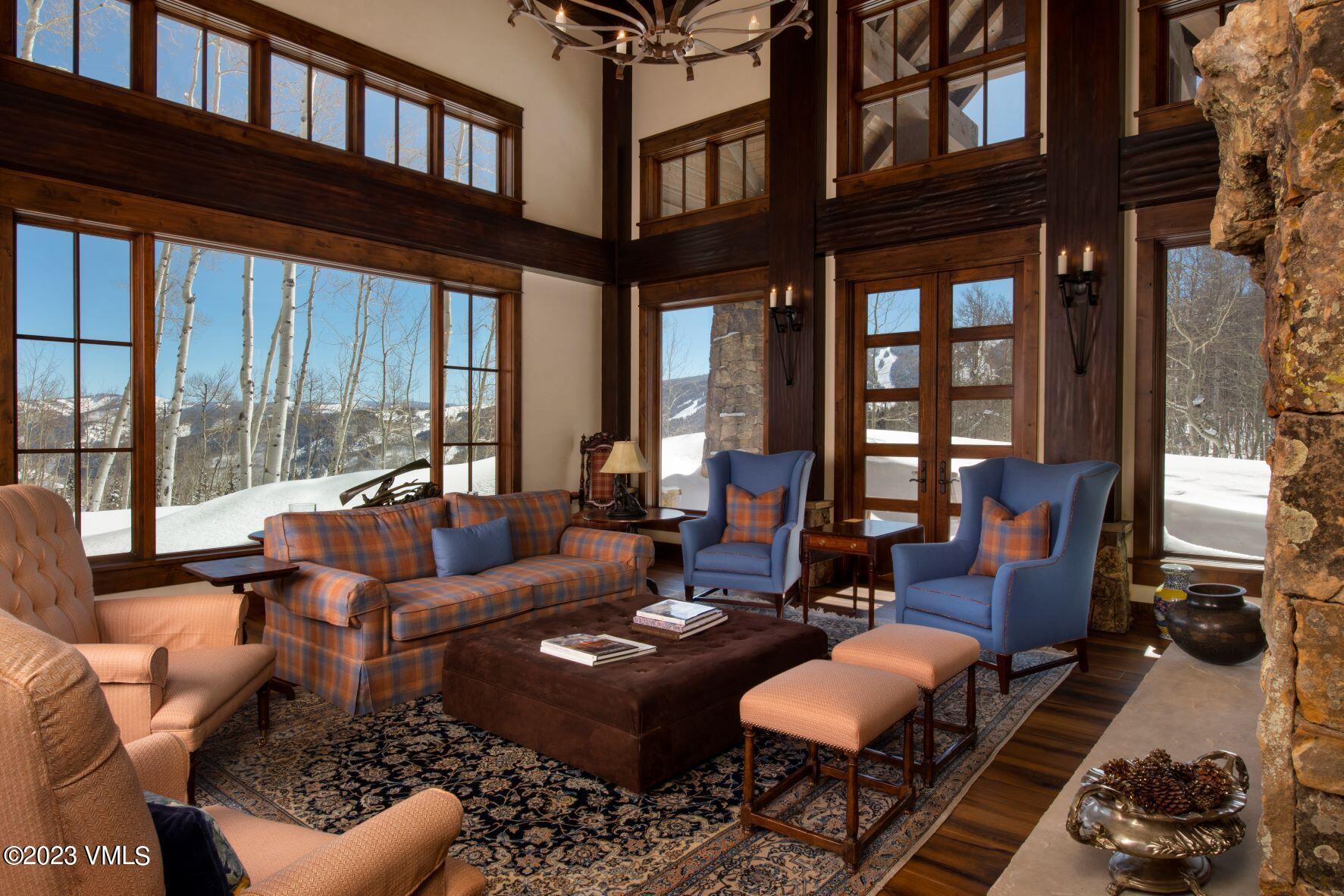 3546 Daybreak Ridge Road Avon, CO 81620 - Photo 2 of 19 a living room with furniture fireplace and a large window
