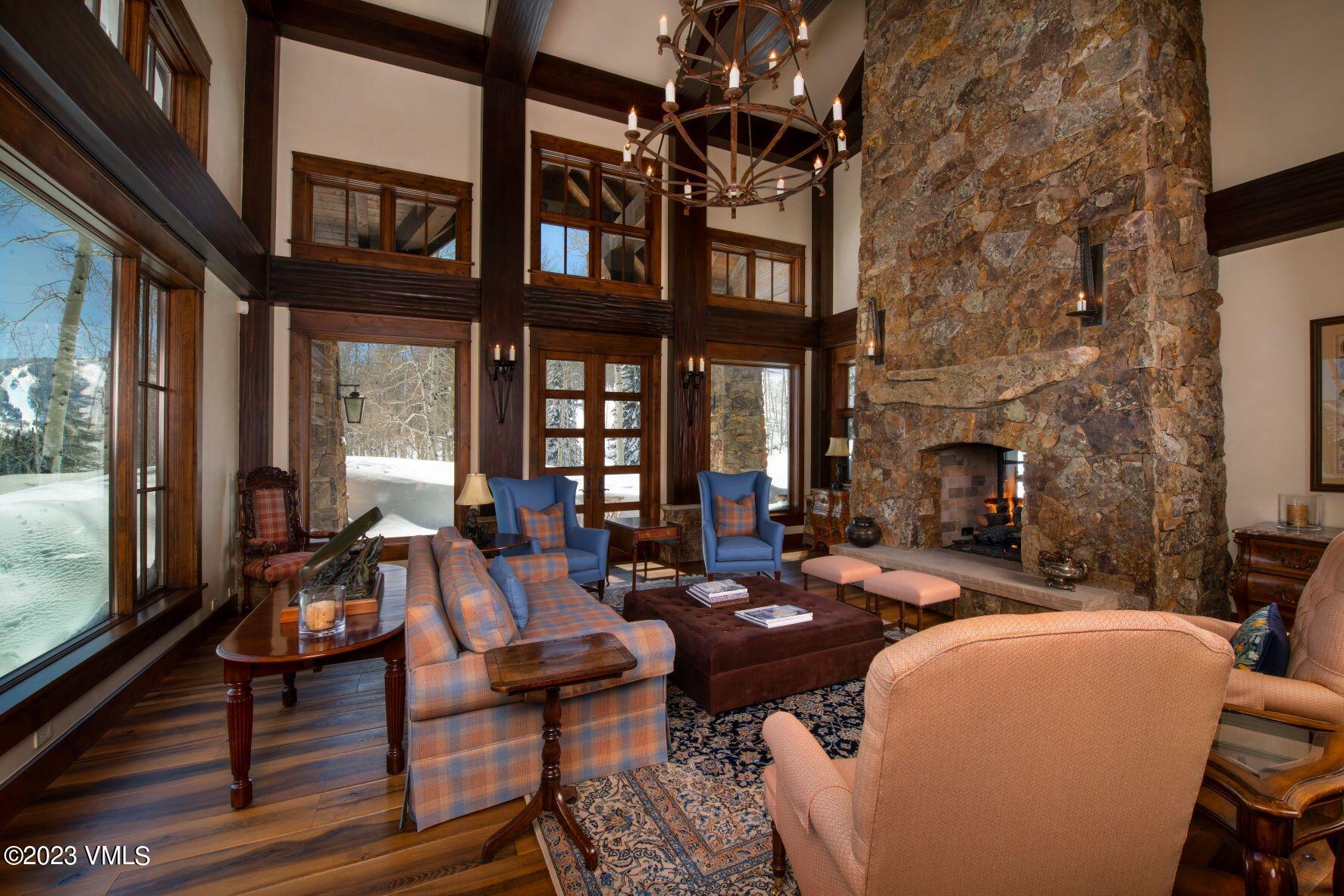3546 Daybreak Ridge Road Avon, CO 81620 - Photo 3 of 19 a living room with fireplace furniture and a floor to ceiling window