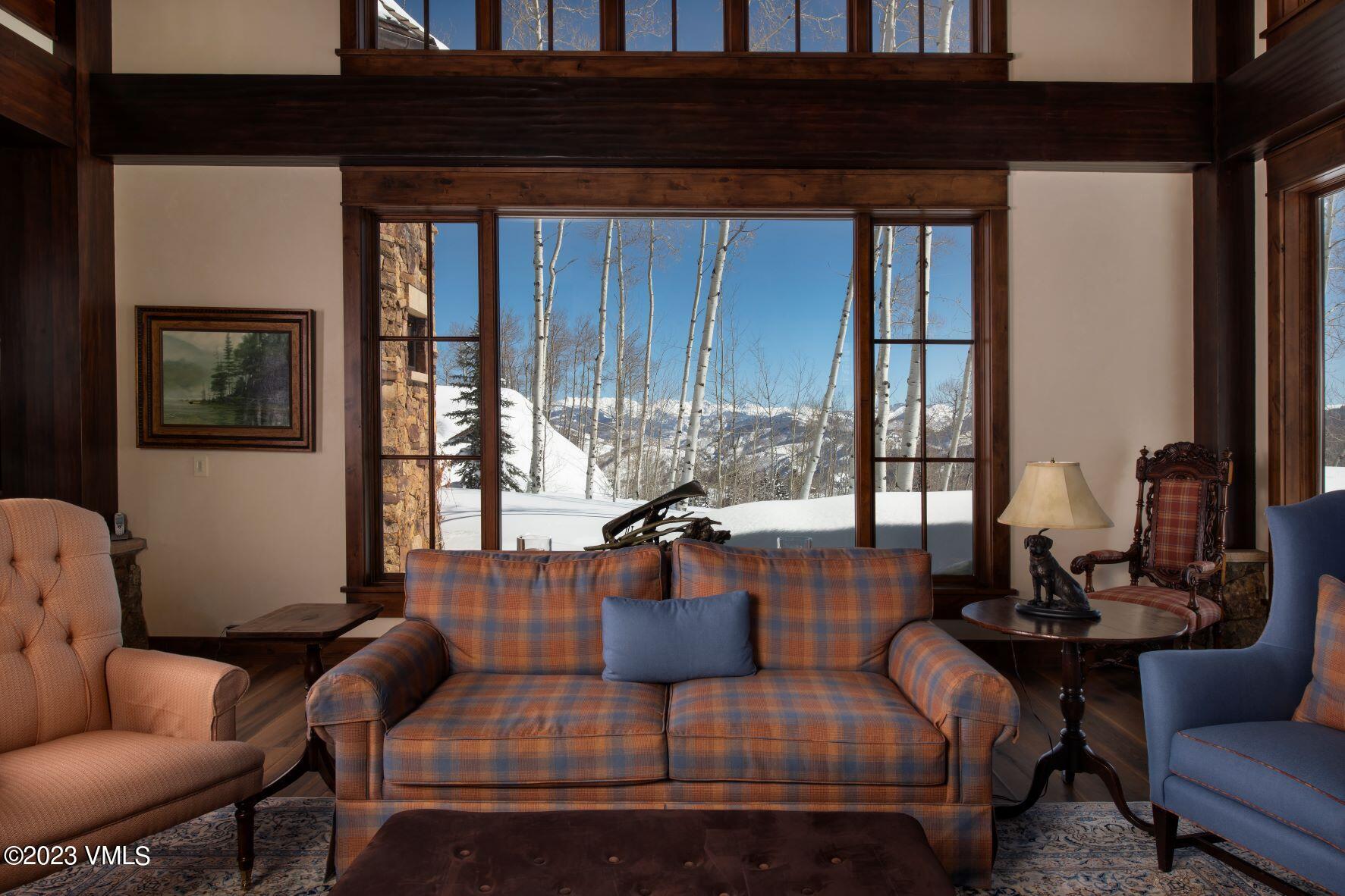3546 Daybreak Ridge Road Avon, CO 81620 - Photo 5 of 19 a living room with fireplace furniture and a large window
