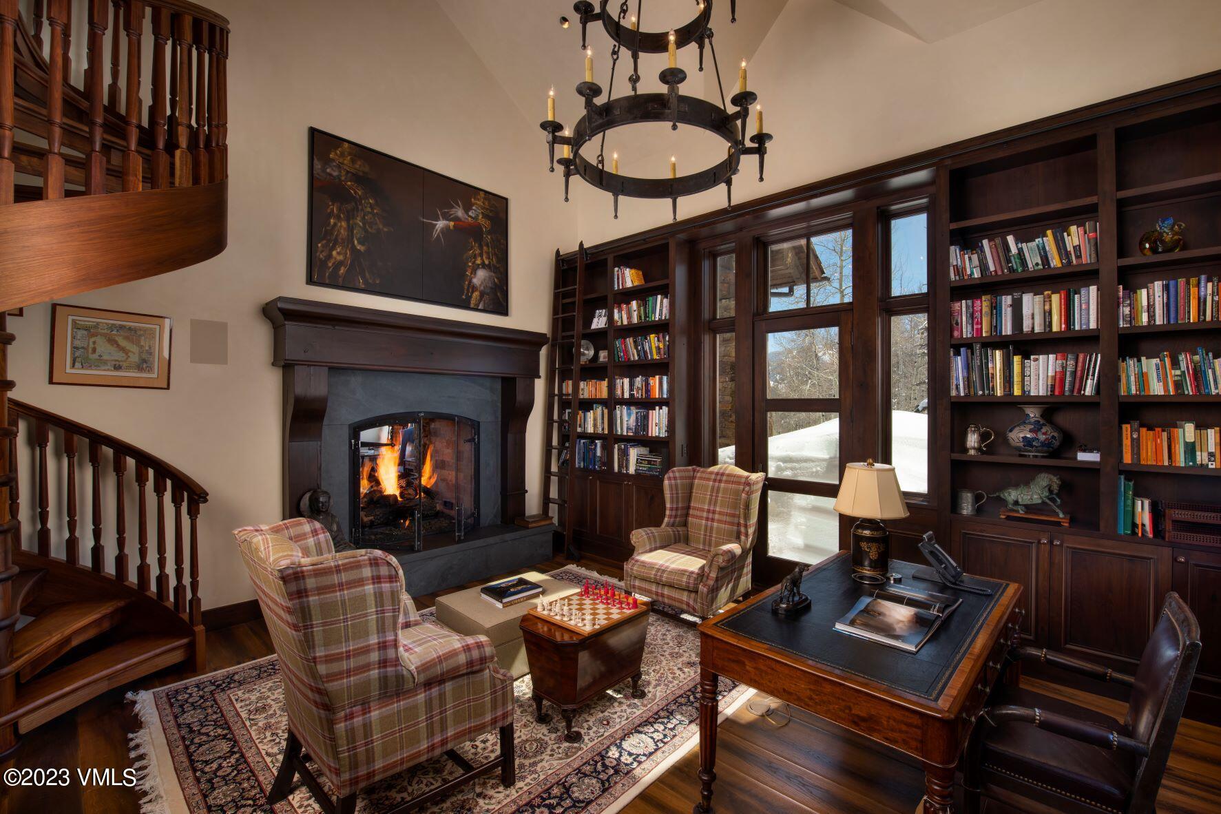 3546 Daybreak Ridge Road Avon, CO 81620 - Photo 6 of 19 a living room with furniture a rug and a fireplace