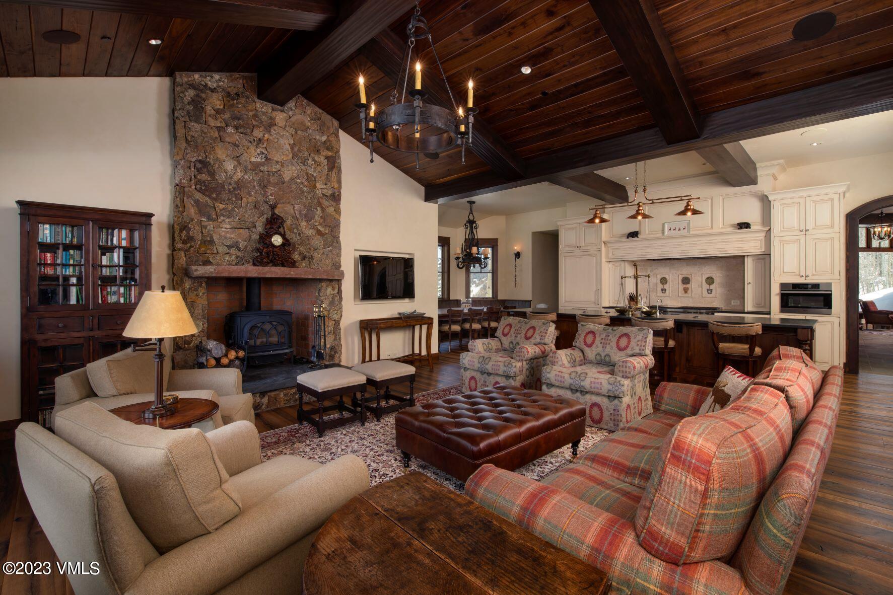 3546 Daybreak Ridge Road Avon, CO 81620 - Photo 8 of 19 a living room with furniture a fireplace and a flat screen tv