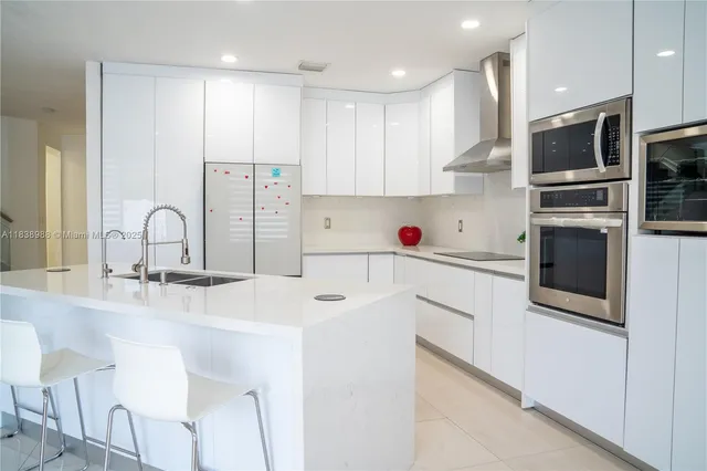 a kitchen with a sink a microwave and cabinets