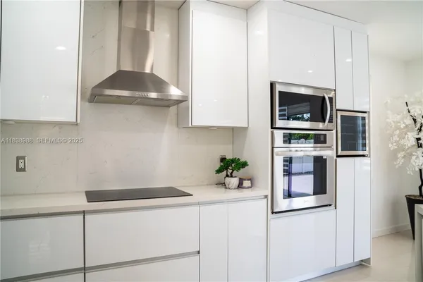 a kitchen with stainless steel appliances white cabinets and a stove