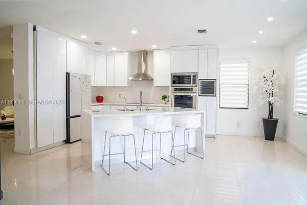 a kitchen with kitchen island cabinets and refrigerator
