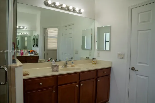 a bathroom with a sink mirror vanity and bathtub