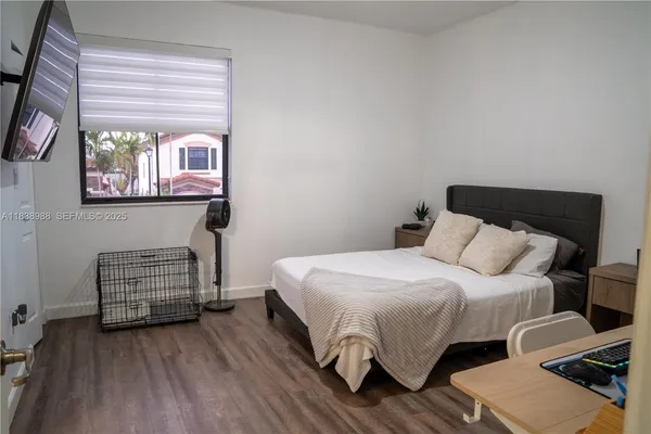 a view of a livingroom with furniture and a flat screen tv