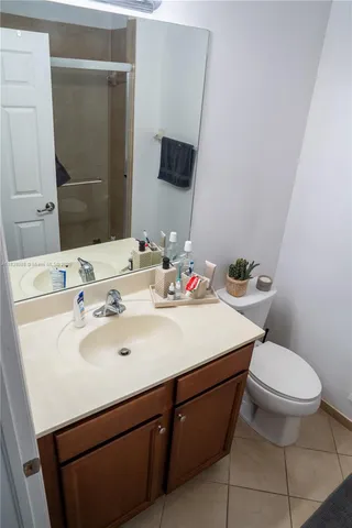 a bathroom with a sink toilet and mirror