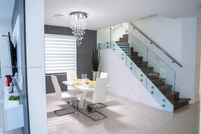 a view of hall way with furniture and stairs