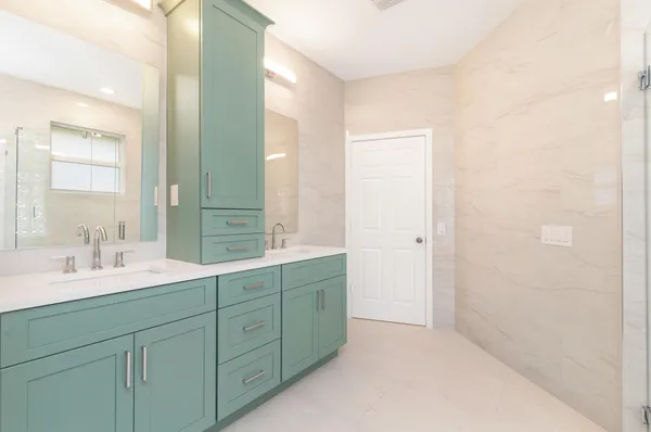 a spacious bathroom with a double vanity sink mirror and