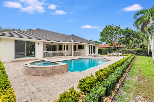 a front view of a house with swimming pool and porch