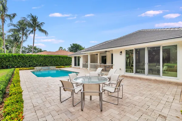 a view of a house with backyard sitting area and garden