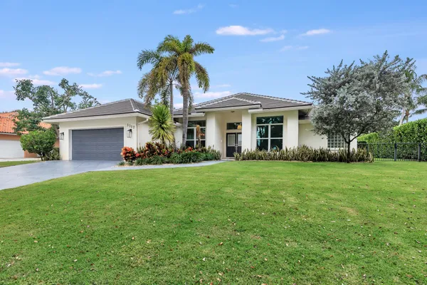a front view of house with yard and green space