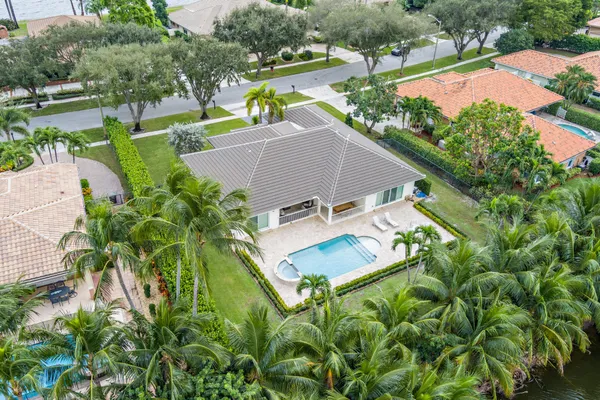 an aerial view of a house with a garden and swimming pool