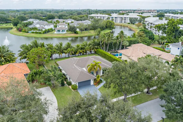 an aerial view of a house with a garden and lake view