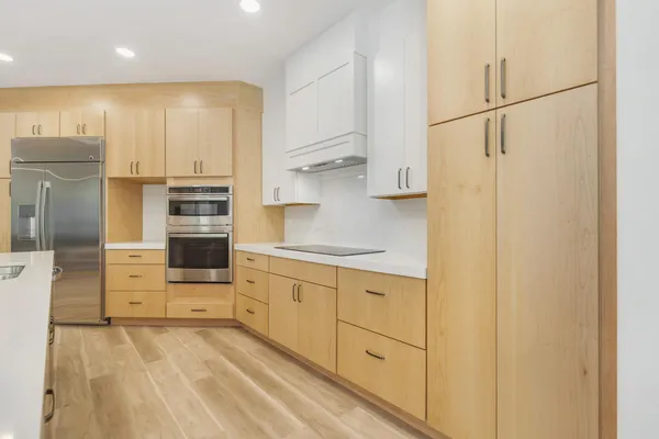 a kitchen with stainless steel appliances a refrigerator sink and cabinets