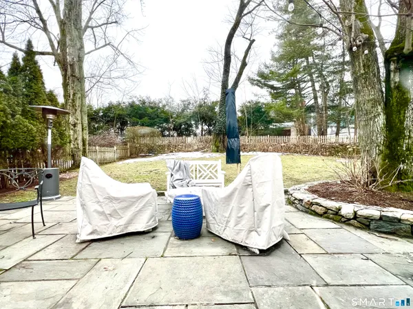 a view of a patio with couches and a fire pit