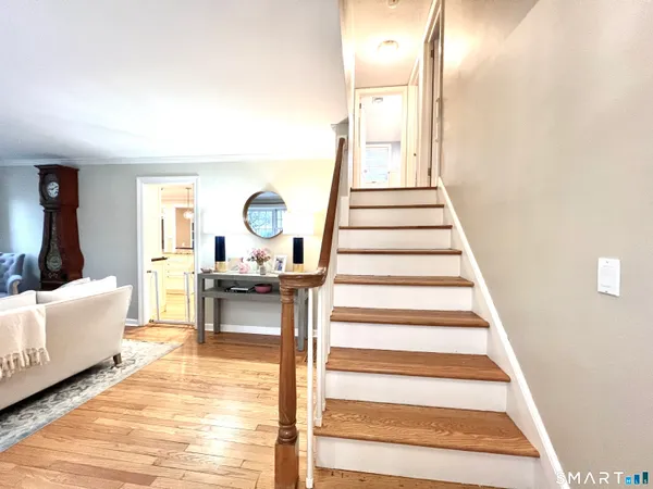 a view of entryway and hall with wooden floor