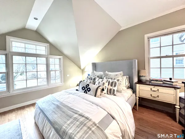 a bedroom with a bed and a large window