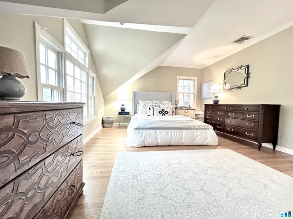 a spacious bedroom with a bed and window