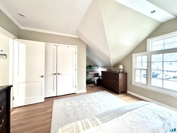 a spacious bedroom with a bed and a large window