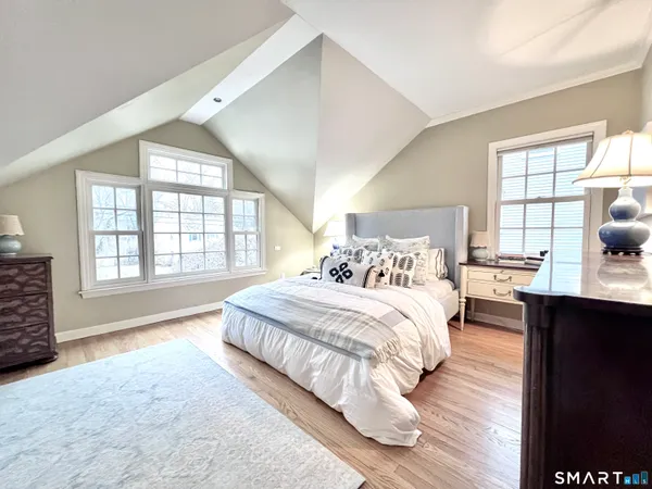 a spacious bedroom with a large bed and a window