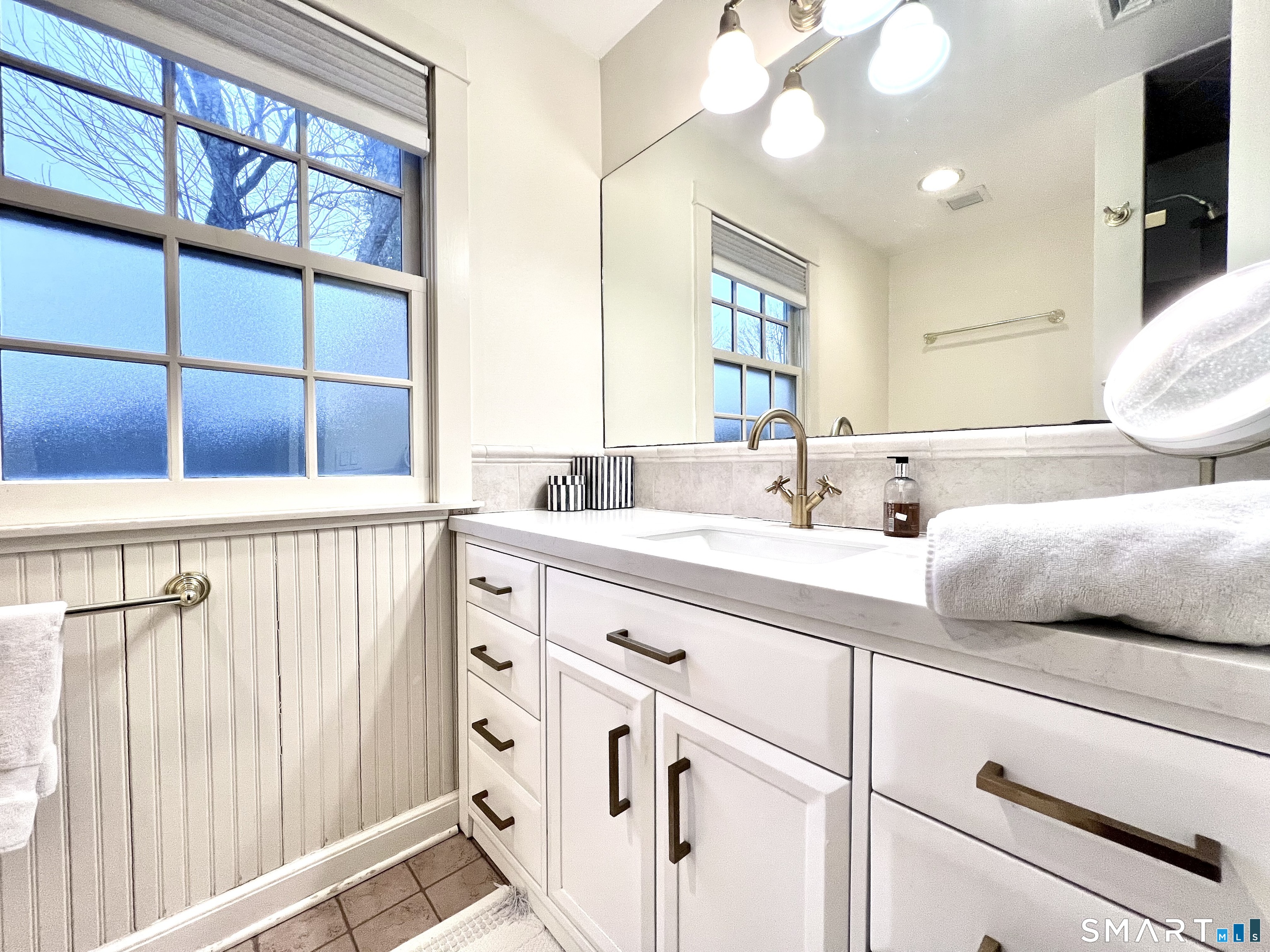 14 Laforge Road Darien, CT 06820 - Photo 25 of 35 a bathroom with a double vanity sink and a mirror