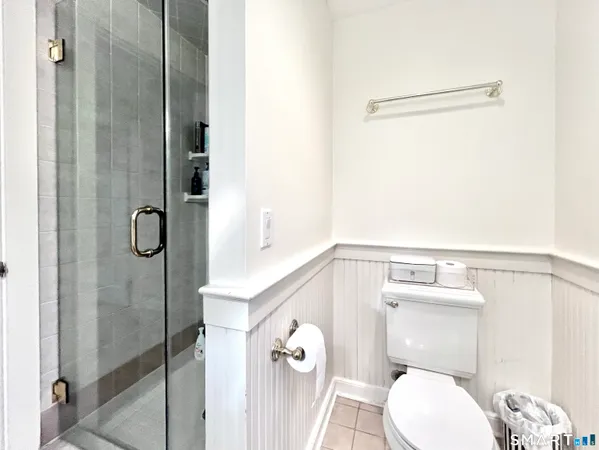 a bathroom with a toilet and a shower