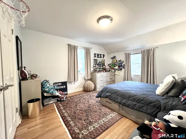 a bedroom with furniture and a wooden floor