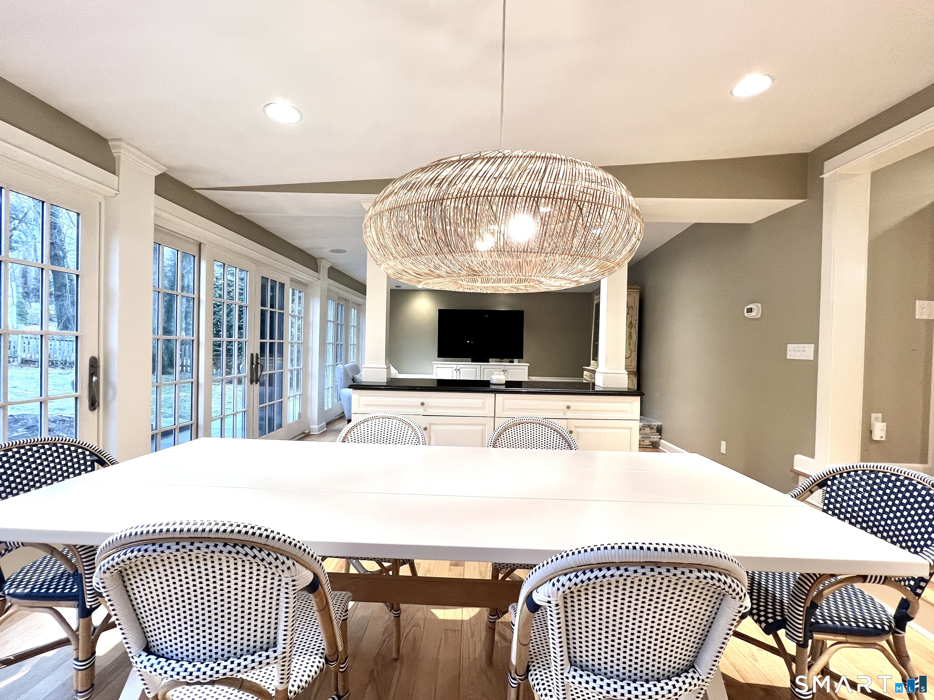 14 Laforge Road Darien, CT 06820 - Photo 33 of 35 a living room with a table chairs and a chandelier