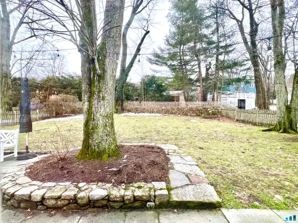 a view of a backyard with large trees