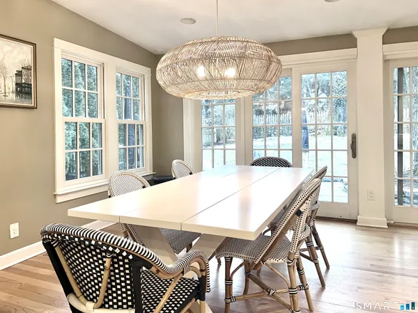 a view of a dining room with furniture wooden floor and chandelier