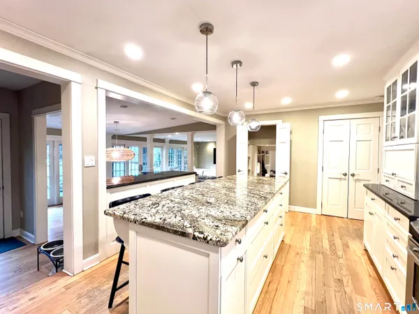 a spacious bathroom with a granite countertop sink and a large mirror