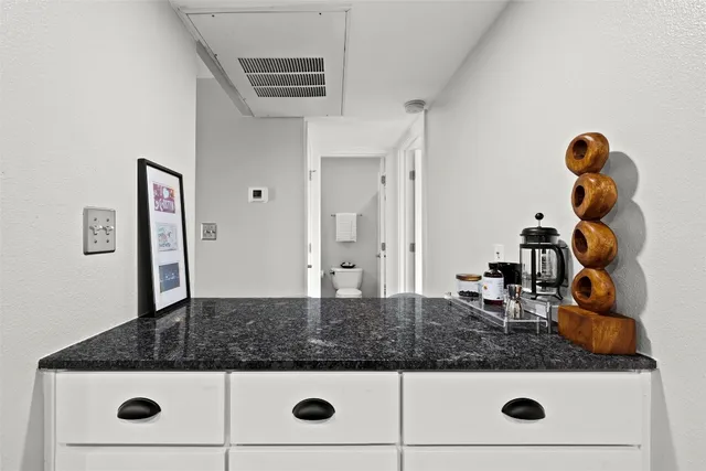 a bathroom with a granite countertop sink and mirror