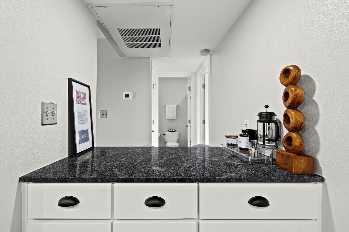 2200 Dickson Drive, Unit 108 Austin, TX 78704 - Photo 12 of 34 a bathroom with a granite countertop sink and mirror