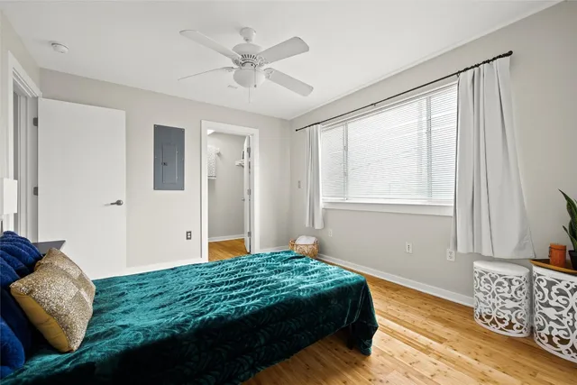 a bedroom with a large bed and a window