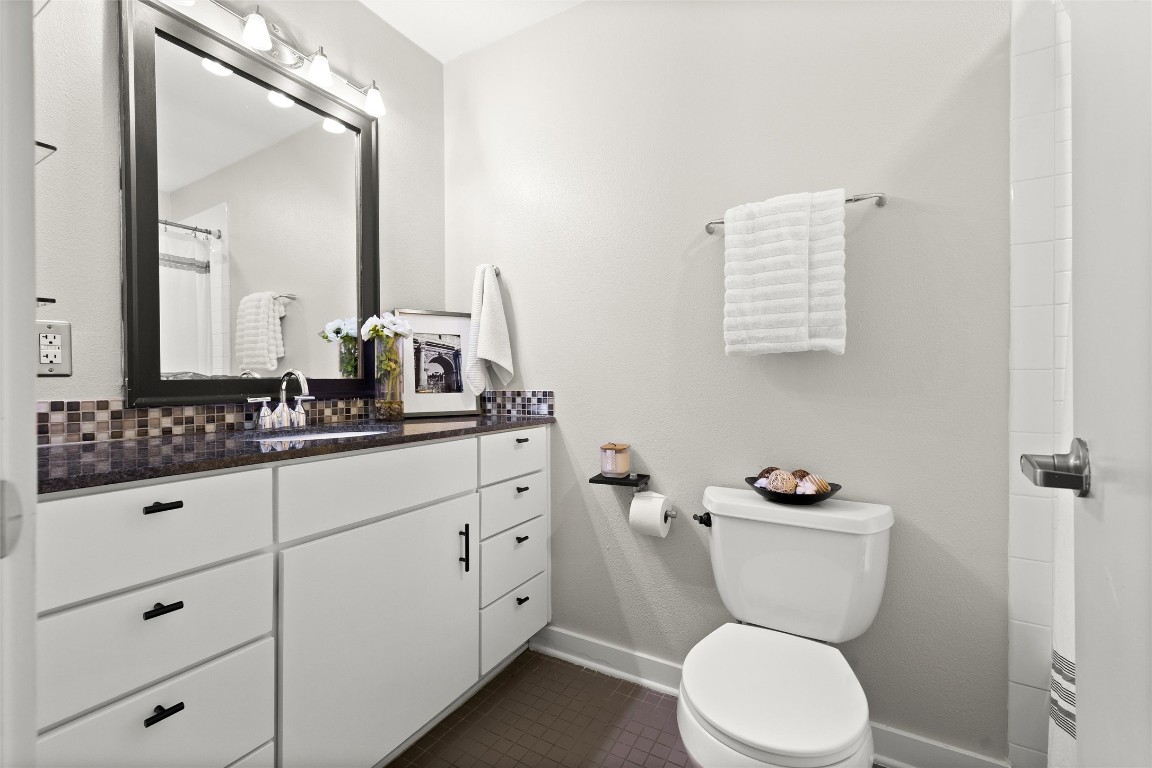 2200 Dickson Drive, Unit 108 Austin, TX 78704 - Photo 18 of 34 a bathroom with a toilet sink and mirror
