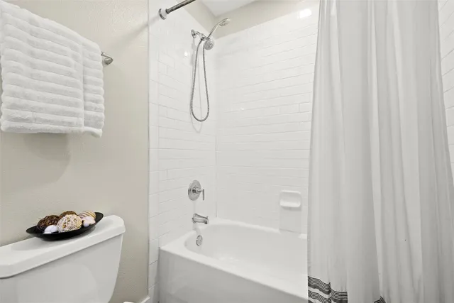 a bathroom with a sink a bath tub and shower curtain