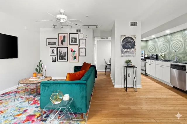 a living room with furniture and wooden floor