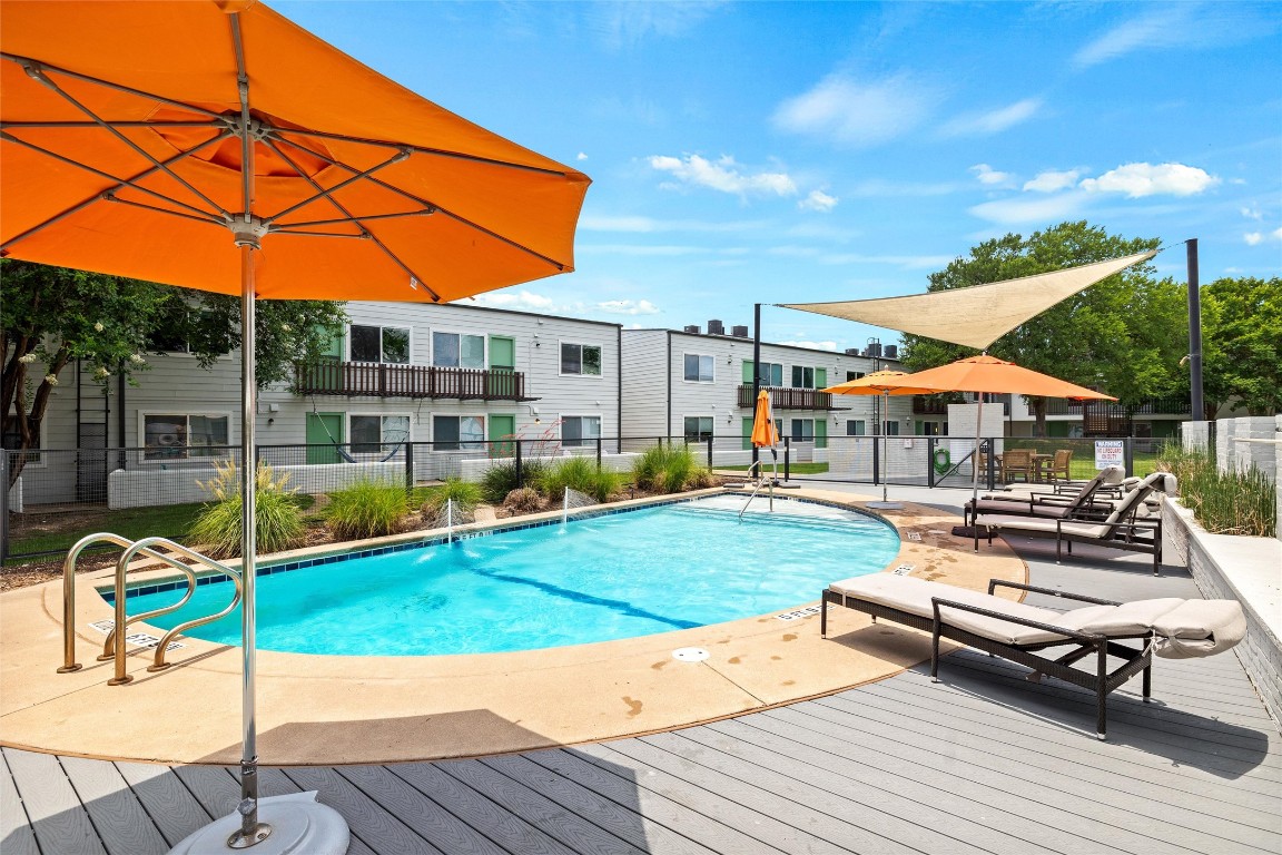 2200 Dickson Drive, Unit 108 Austin, TX 78704 - Photo 20 of 34 a view of a patio with a table and chairs under an umbrella