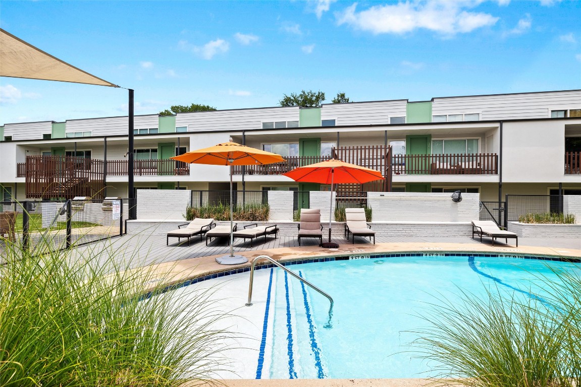 2200 Dickson Drive, Unit 108 Austin, TX 78704 - Photo 21 of 34 a view of a swimming pool with a table and chairs under an umbrella