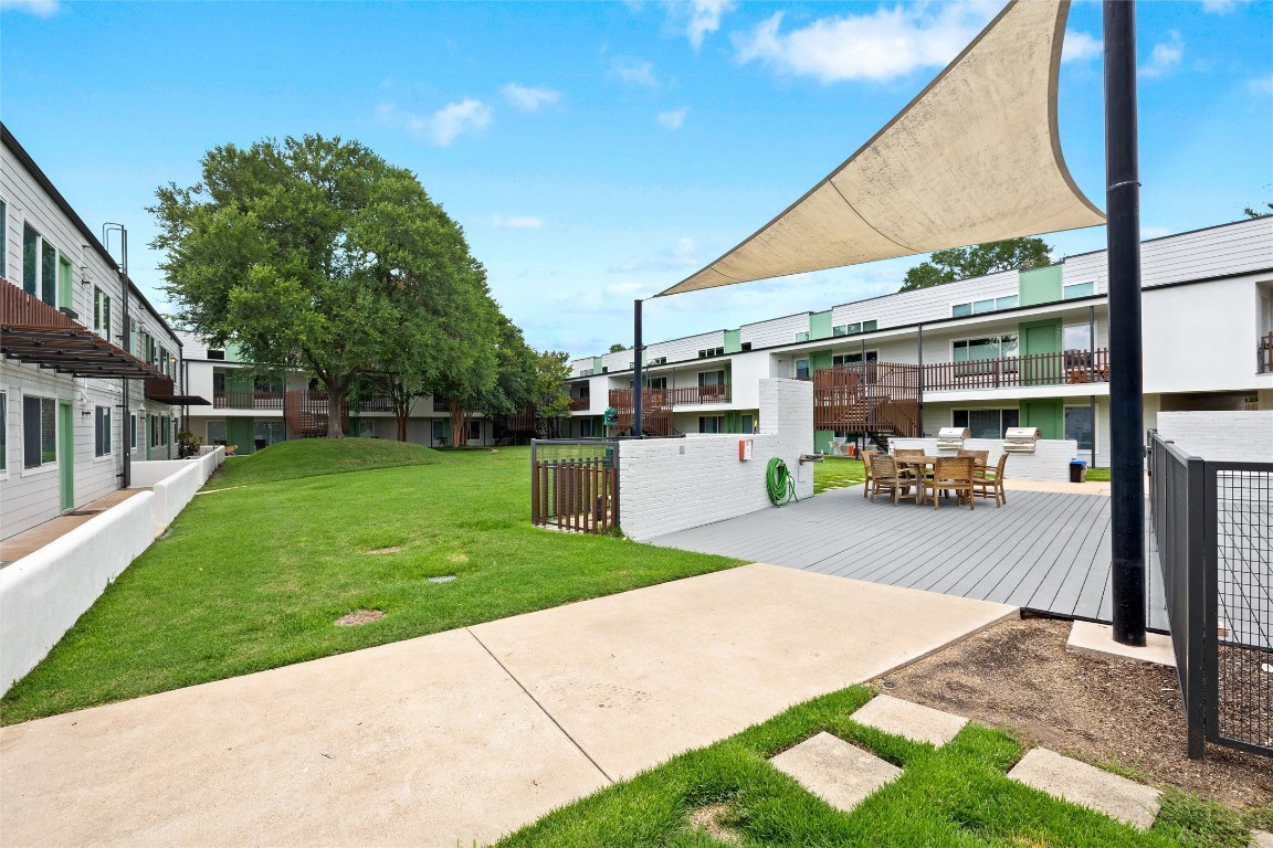 2200 Dickson Drive, Unit 108 Austin, TX 78704 - Photo 22 of 34 a front view of a house with a yard and table and chairs
