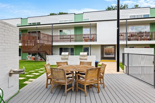 a view of a table and chairs on the roof deck