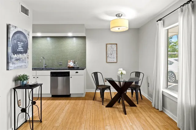 a view of a dining room with furniture and wooden floor