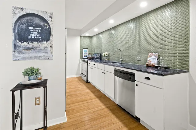 a kitchen with stainless steel appliances a sink and a stove