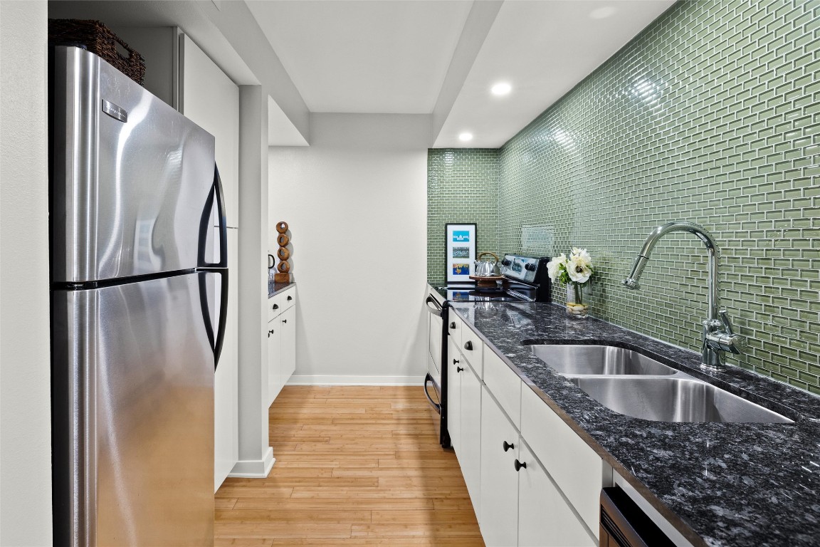 2200 Dickson Drive, Unit 108 Austin, TX 78704 - Photo 9 of 34 a kitchen with stainless steel appliances granite countertop a sink and a refrigerator