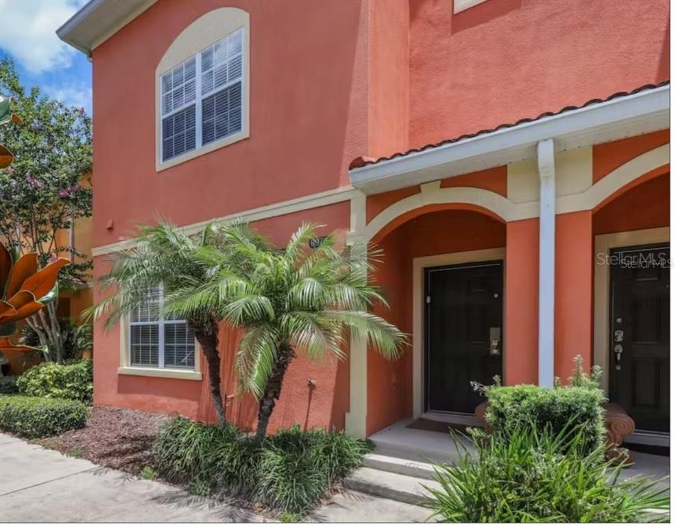 8975 Candy Palm Road Kissimmee, FL 34747 - Photo 1 of 27 front view of a house with potted plants