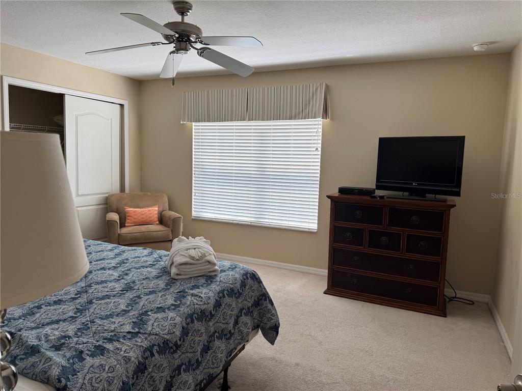 8975 Candy Palm Road Kissimmee, FL 34747 - Photo 12 of 27 a bedroom with a bed and a flat screen television