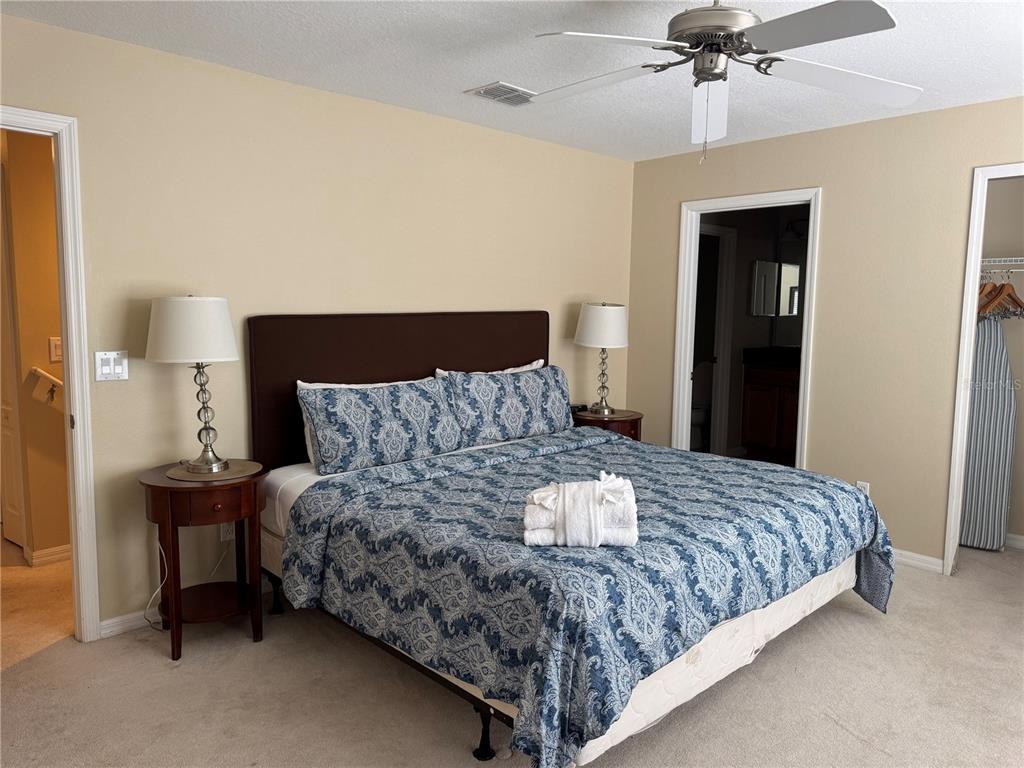 8975 Candy Palm Road Kissimmee, FL 34747 - Photo 13 of 27 a bedroom with a bed and ceiling fan