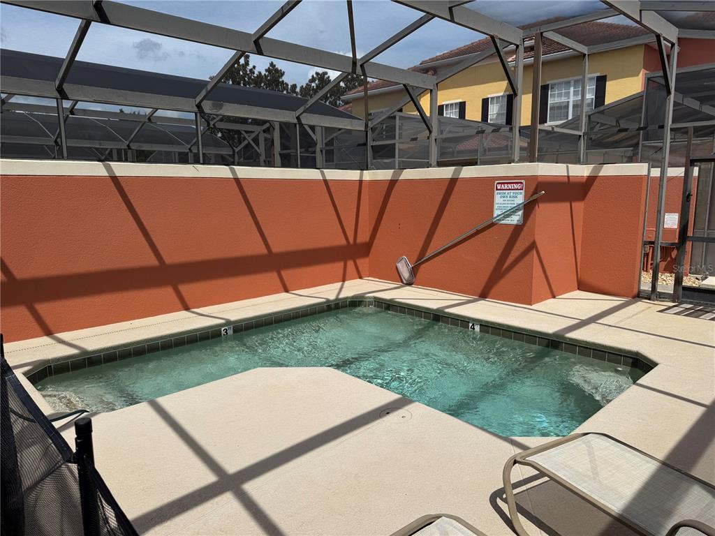 8975 Candy Palm Road Kissimmee, FL 34747 - Photo 22 of 27 a view of a backyard with a table and chairs under an umbrella