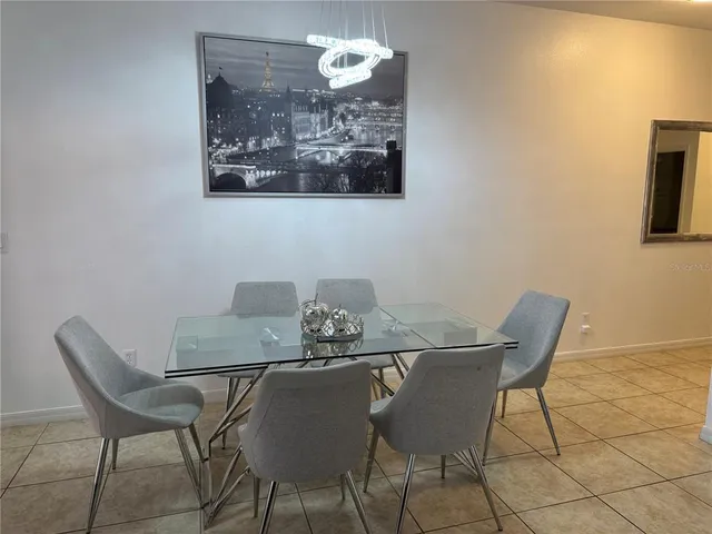 a view of a dining room with furniture and chandelier